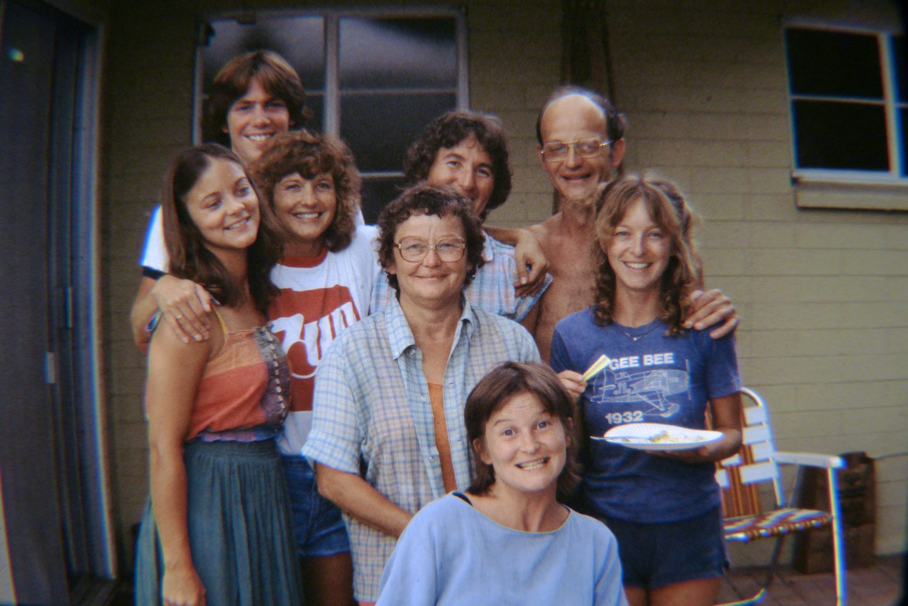 A group of relatives smiling together on a porch