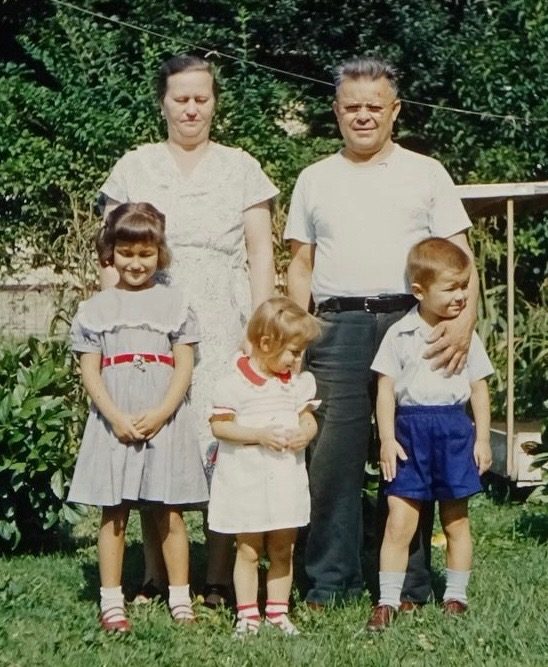 George and Anna Kraynak in the yard with three young children
