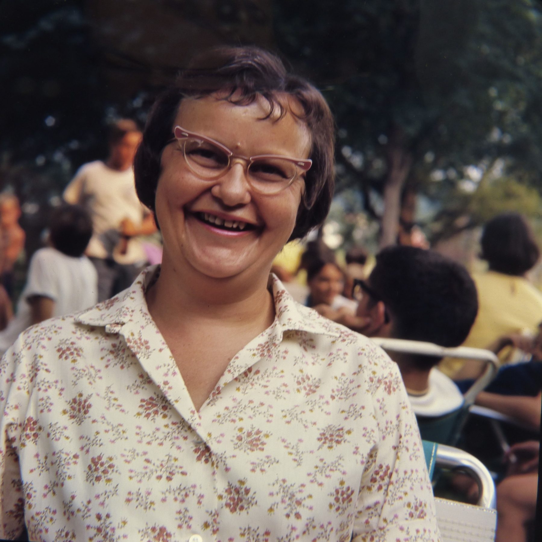 A woman laughing at a family picnic