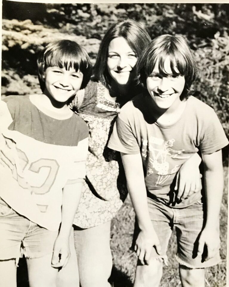 Three kids grinning in the sun